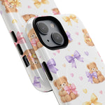 Two sizes of white phone cases with teddy bear and colorful bow pattern, featuring pink, purple, and yellow bows