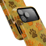 Two iPhone cases in different sizes with brown and orange paw print design on yellow background