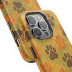 Close-up of two size variants of phone cases with yellow background and brown and orange paw print pattern