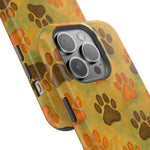 Two phone cases with yellow background and brown and orange paw print pattern, showing size variant