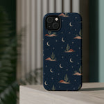 Desert Moon MagSafe Phone Case, glossy diagonal dual-camera model, rear view on a tabletop