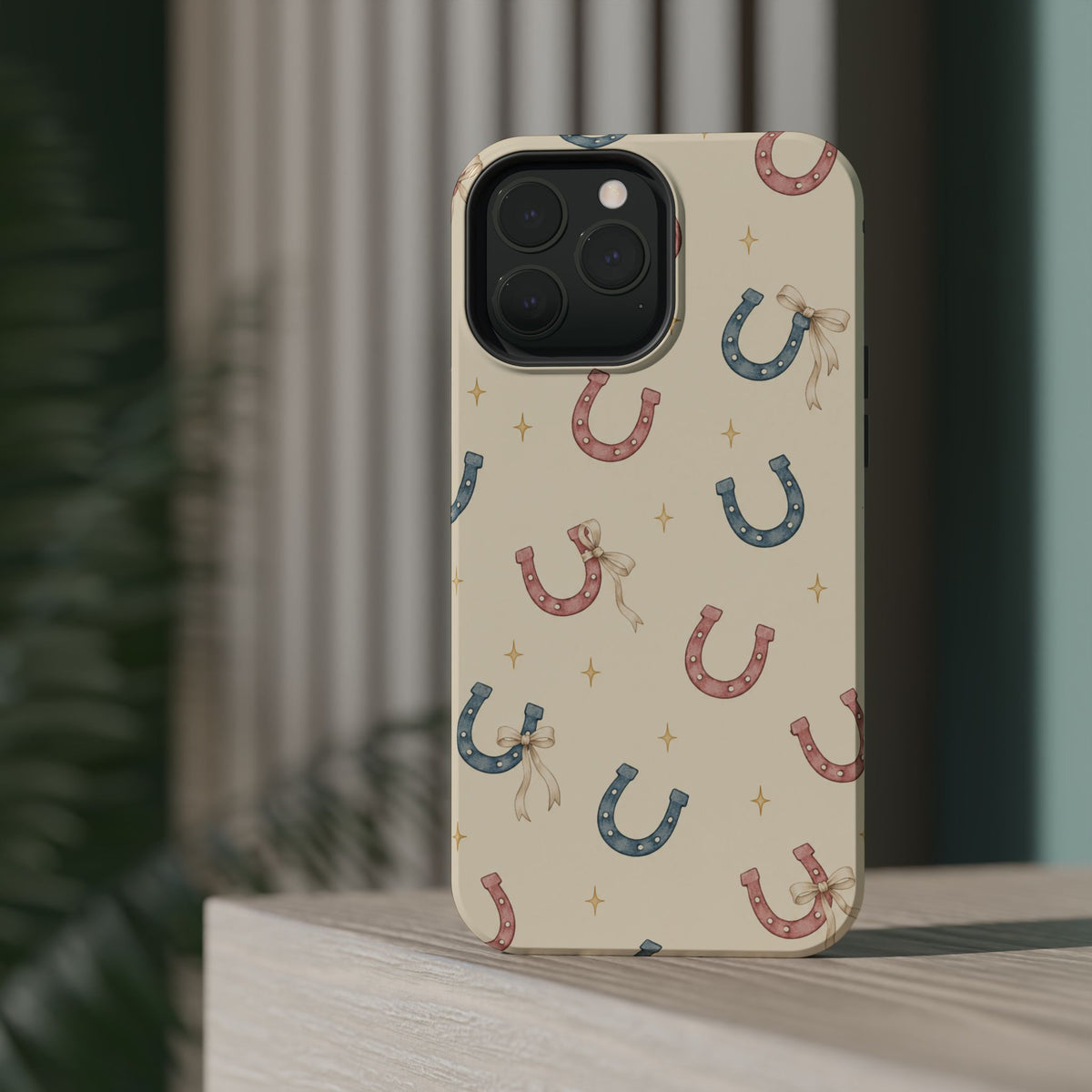 Prairie Horseshoes MagSafe Phone Case, glossy square triple-camera Pro model, rear view on a tabletop