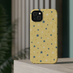 Prairie Stars – Yellow and Blue Star MagSafe Phone Case, glossy diagonal dual-camera model, rear view on a tabletop