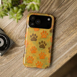iPhone 14 Pro Max in large size with yellow paw print design case on wooden surface