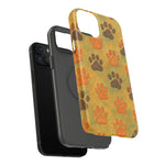 Black smartphone with two protective cases, one plain black and one with orange and brown paw prints, showing variant size