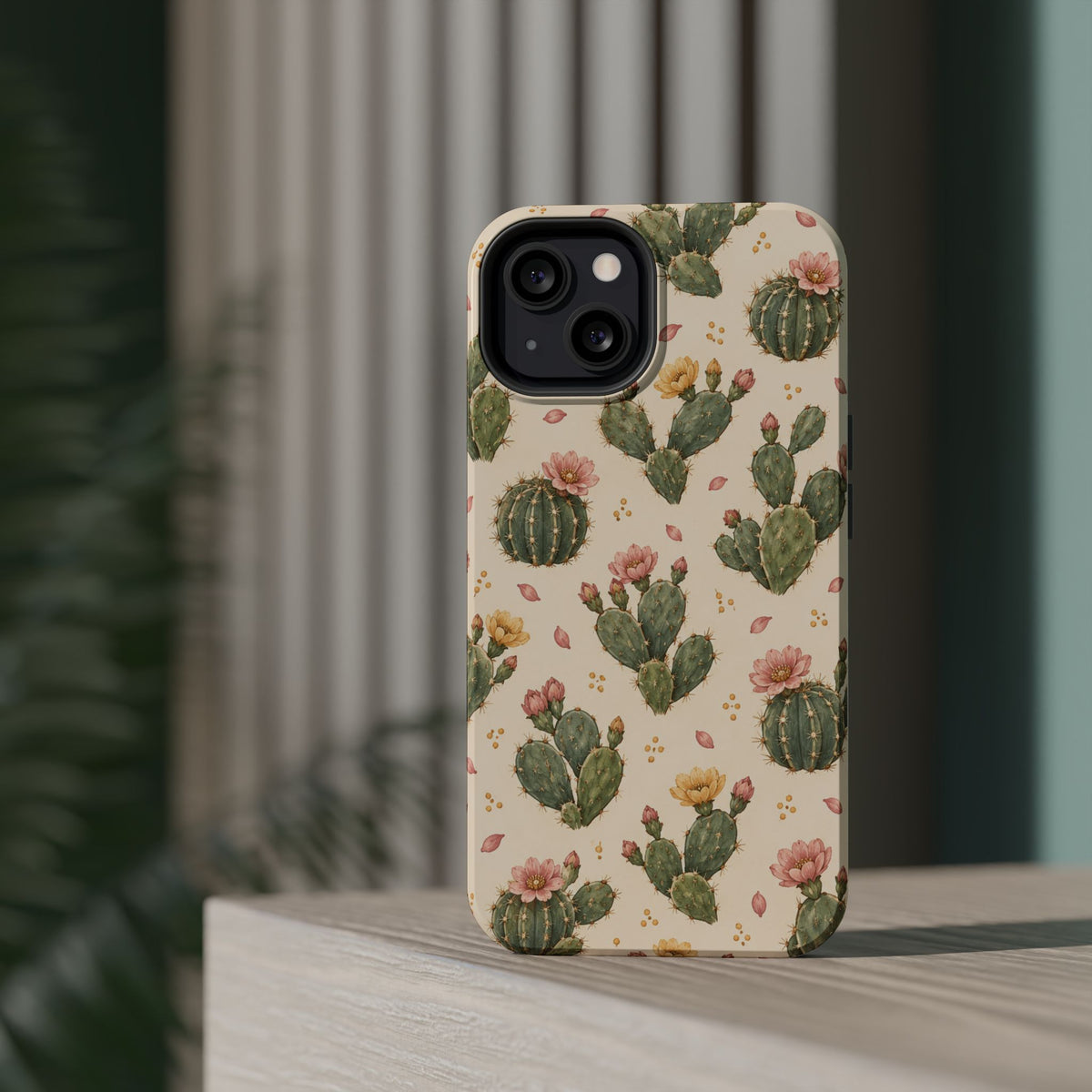 Cactus Bloom – Sage Green Floral Cactus MagSafe Phone Case, glossy diagonal dual-camera model, rear view on a tabletop