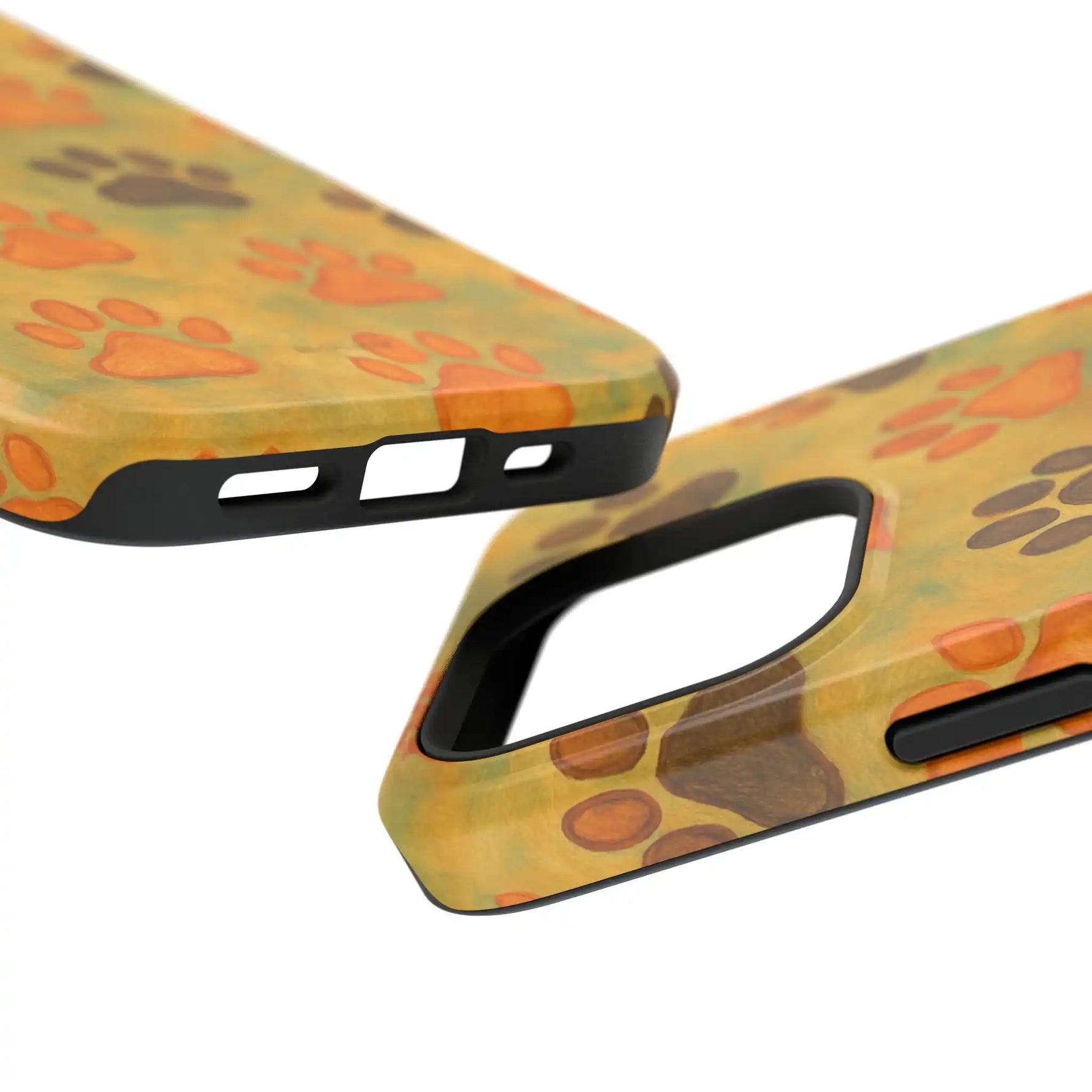 Close-up of two sizes of phone cases with orange and brown paw print design on yellow background