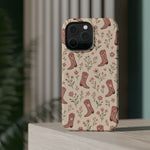 Floral Boots MagSafe Phone Case, glossy square triple-camera Pro model, rear view on a tabletop