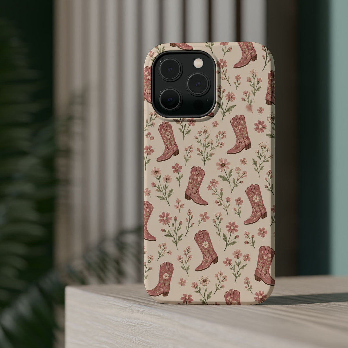 Floral Boots MagSafe Phone Case, glossy square triple-camera Pro model, rear view on a tabletop