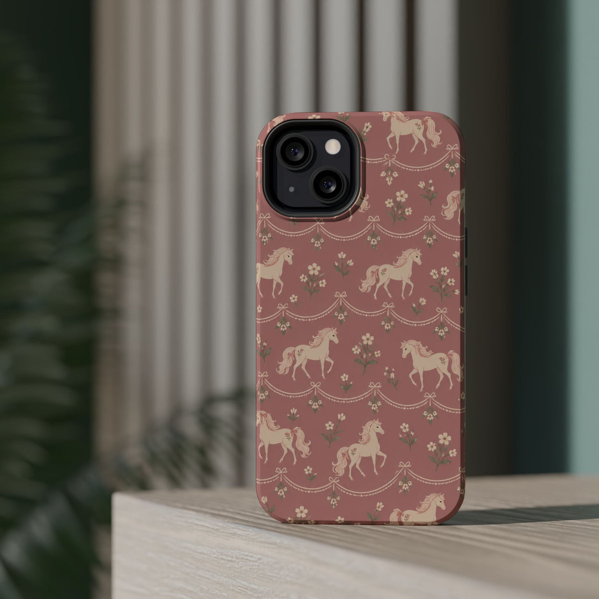 Rose Ponies MagSafe Phone Case, glossy diagonal dual-camera model, rear view on a tabletop