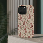 Floral Boots MagSafe Phone Case, glossy square triple-camera Pro model, rear view on a tabletop