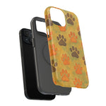 iPhone with black case and decorative yellow phone case featuring brown and orange paw prints, showing size variant