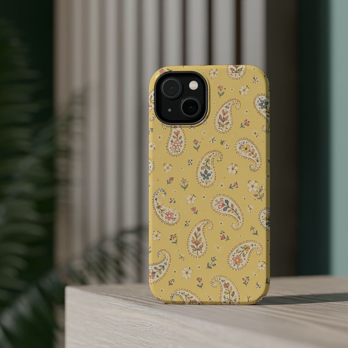 Honey Paisley MagSafe Phone Case, glossy diagonal dual-camera model, rear view on a tabletop