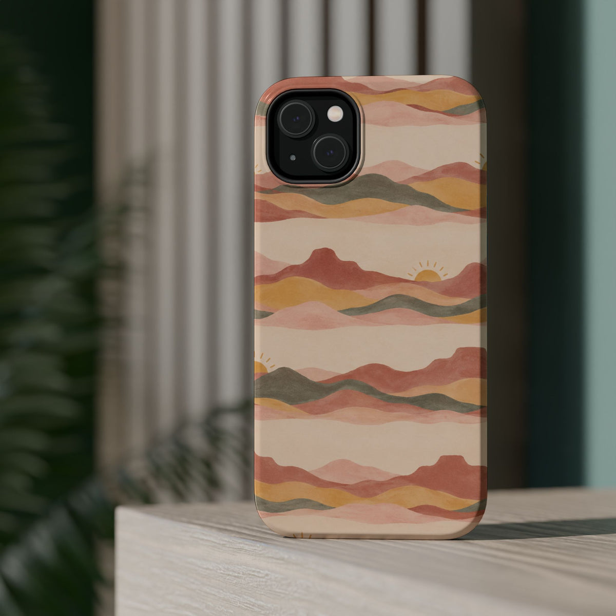 Sunset Trails – Desert Landscape MagSafe Phone Case, glossy diagonal dual-camera model, rear view on a tabletop