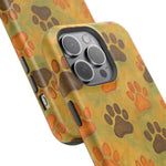 Two phone cases with orange and brown paw print designs showing different sizes