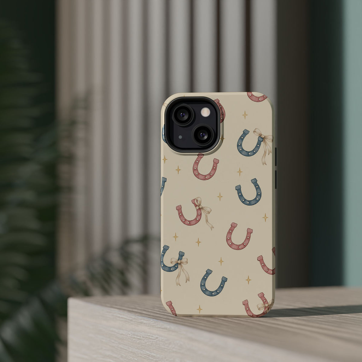 Prairie Horseshoes MagSafe Phone Case, glossy diagonal dual-camera model, rear view on a tabletop