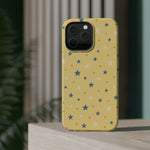 Prairie Stars – Yellow and Blue Star MagSafe Phone Case, glossy square triple-camera Pro model, rear view on a tabletop