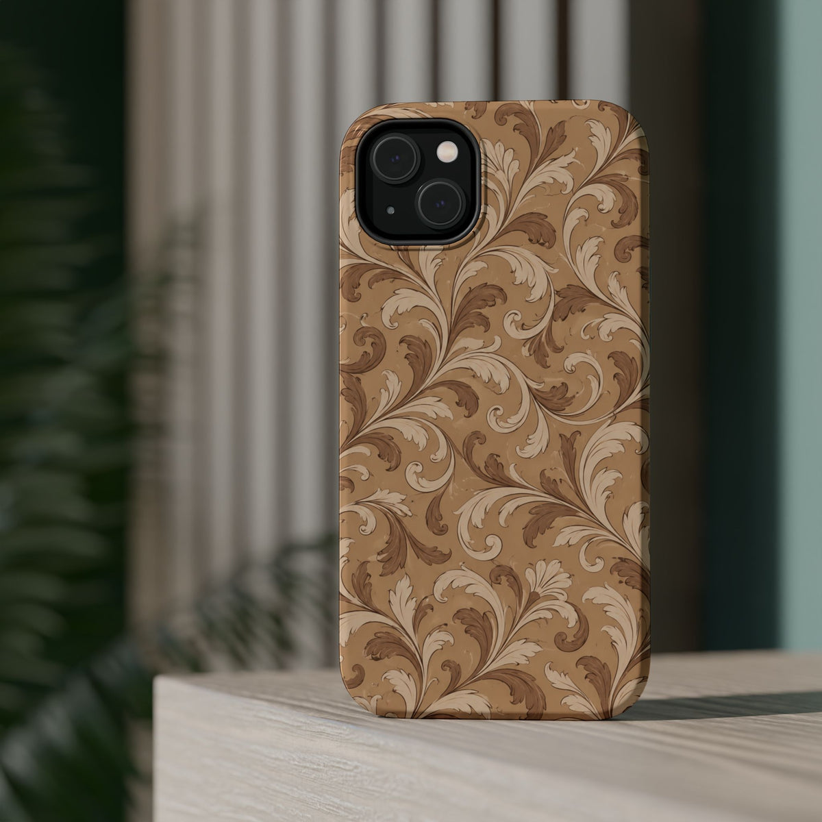 Saddle Scrolls – Tan Western Scrollwork MagSafe Phone Case, glossy diagonal dual-camera model, rear view on a tabletop