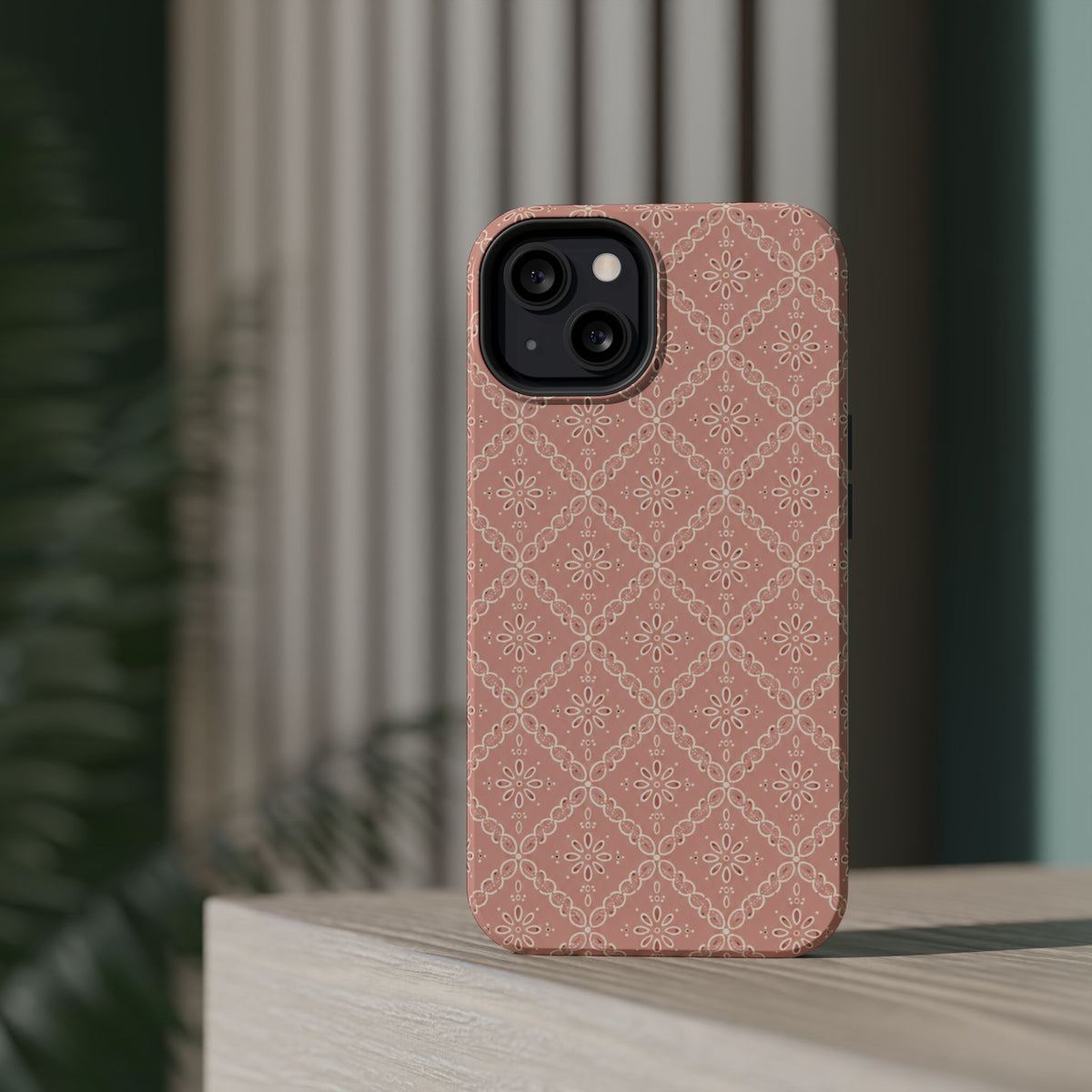 Meadow Lace – Blush Pink Lace Pattern MagSafe Phone Case, glossy diagonal dual-camera model, rear view on a tabletop