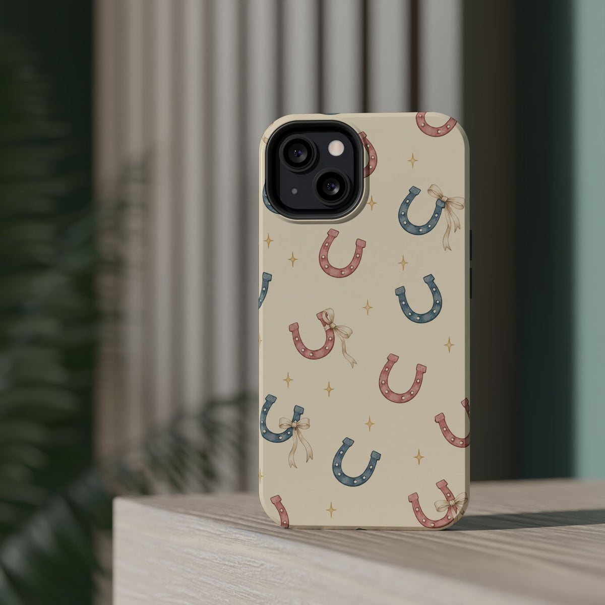 Prairie Horseshoes MagSafe Phone Case, glossy diagonal dual-camera model, rear view on a tabletop