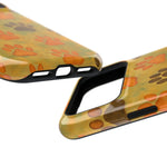Two close-up views of glossy phone cases with orange and brown paw print patterns, showing different size variants