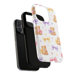 iPhone with black case and a detachable white phone case featuring teddy bears, pastel bows, and hearts pattern showing variant size
