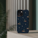 Desert Moon MagSafe Phone Case, glossy diagonal dual-camera model, rear view on a tabletop