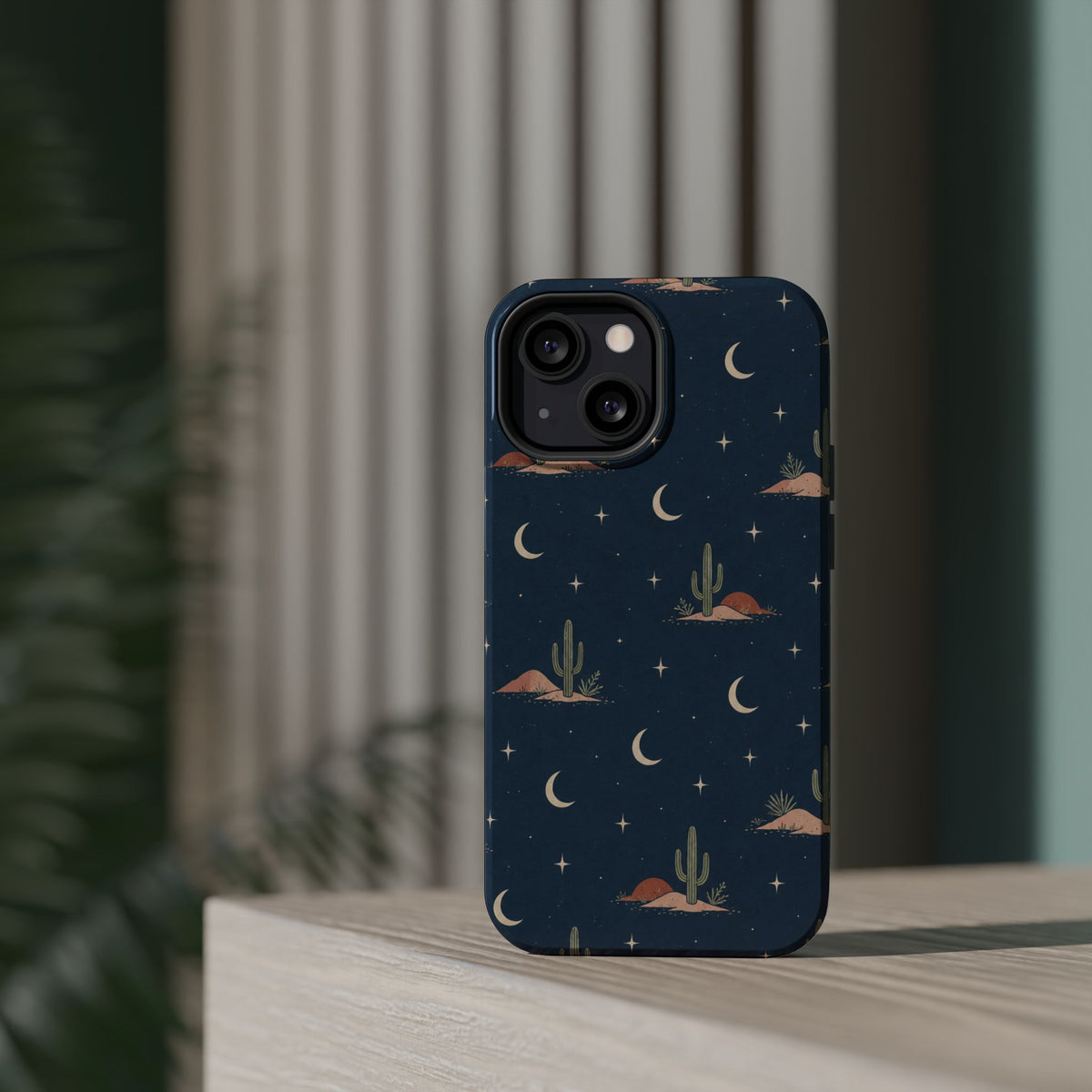 Desert Moon MagSafe Phone Case, glossy diagonal dual-camera model, rear view on a tabletop