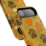 Close-up of two pet paw print phone cases with orange and brown paw patterns showing different sizes