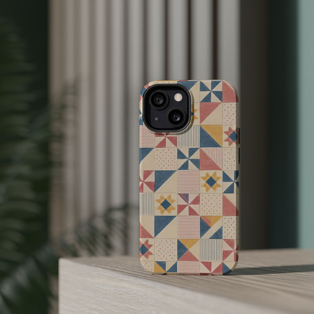 Prairie Quilt – Pastel Patchwork Pattern MagSafe Phone Case, glossy diagonal dual-camera model, rear view on a tabletop