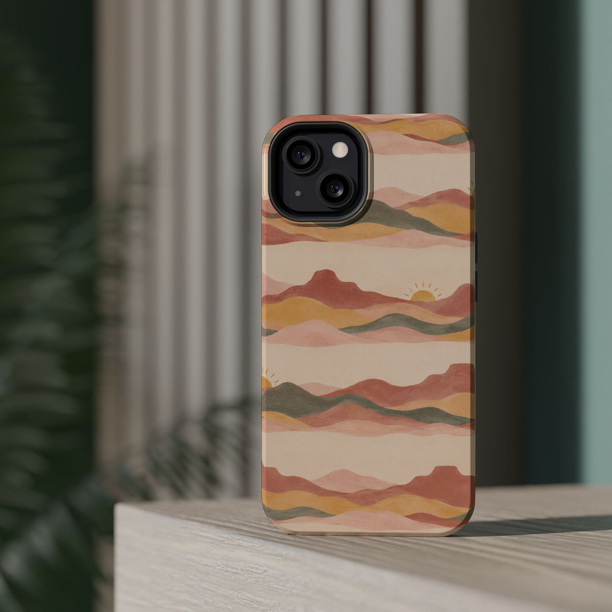 Sunset Trails – Desert Landscape MagSafe Phone Case, glossy diagonal dual-camera model, rear view on a tabletop