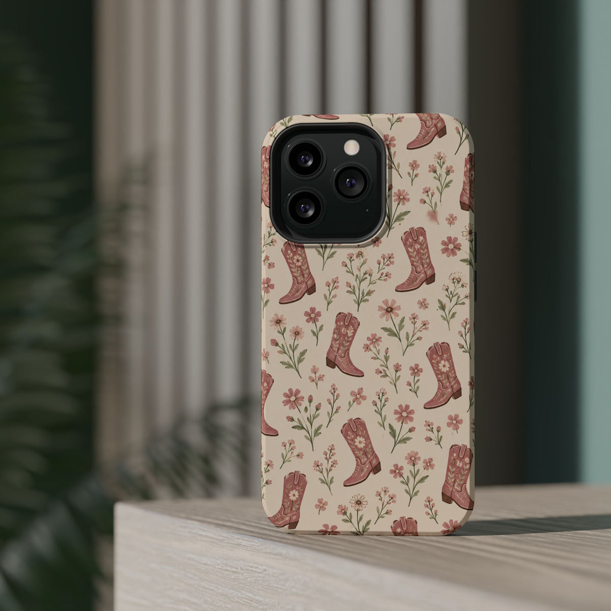 Floral Boots MagSafe Phone Case, glossy square triple-camera Pro model, rear view on a tabletop