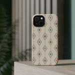 Desert Diamonds – Pastel Geometric Pattern MagSafe Phone Case, glossy diagonal dual-camera model, rear view on a tabletop