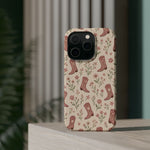 Floral Boots MagSafe Phone Case, glossy square triple-camera Pro model, rear view on a tabletop
