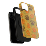 iPhone with two cases shown - black protective case and paw print design case in yellow orange brown variant sizes