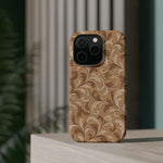 Saddle Scrolls – Tan Western Scrollwork MagSafe Phone Case, glossy square triple-camera Pro model, rear view on a tabletop