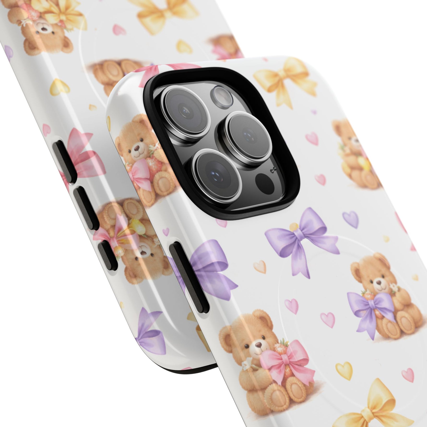 Close-up of two iPhone cases in different sizes with teddy bear and colorful bow pattern on white background