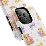 Two white phone cases with teddy bear and pastel bow pattern, showing variant size for triple camera phones