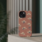 Ribbon Rodeo – Cowgirl Hat and Bow MagSafe Phone Case, Pink, glossy diagonal dual-camera model, rear view on a tabletop