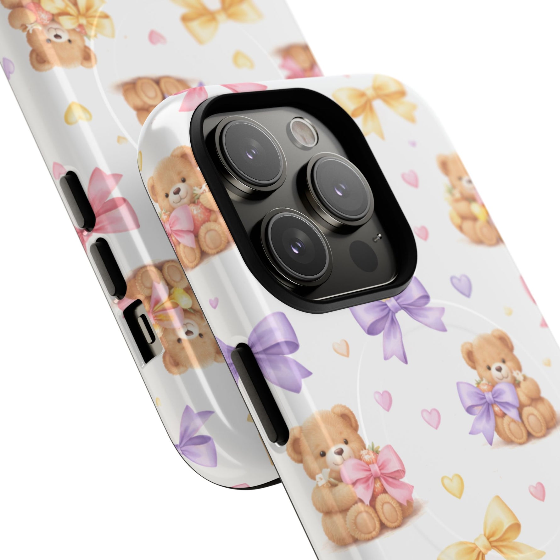 Close-up of two phone cases with cute teddy bear and pastel bow pattern, showing different sizes