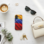 Flat lay with Venezuelan flag case and accessories