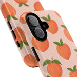 Close-up of overlapping peach-pattern cases with vertical dual-camera opening #iphone-16