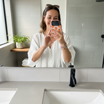 Woman holding a peach-pattern wide-camera case for a mirror selfie #iphone-17-pro