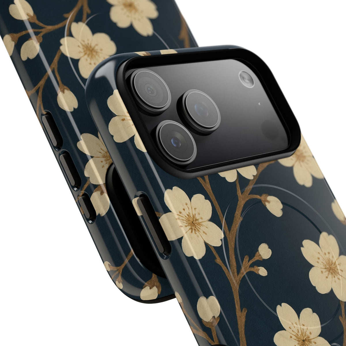 Close-up of overlapping navy cherry-blossom cases with wide triple-camera opening and side controls #iphone-17-pro-max