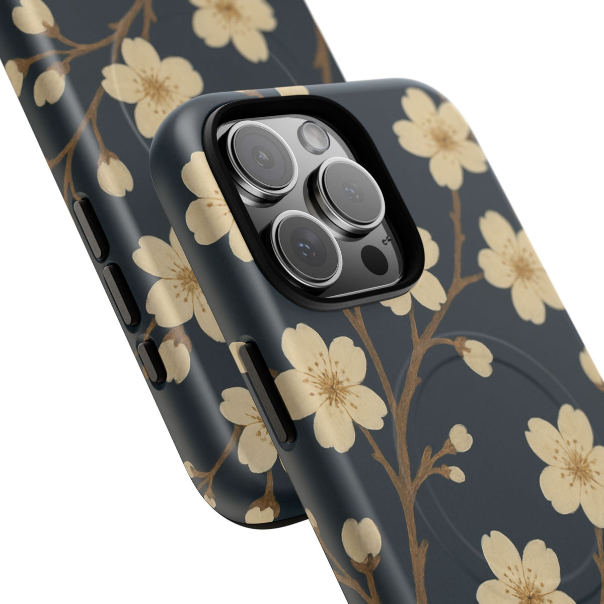 Close-up of overlapping navy cherry-blossom cases with square triple-camera opening and side controls #iphone-15-pro