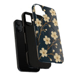 Exploded navy cherry-blossom case showing the phone, liner and shell with a vertical dual-camera opening #iphone-16