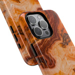 Close-up of overlapping amber agate marble cases with square triple-camera opening and side controls #iphone-16-pro-max