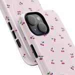 Close-up of overlapping cherry-pattern cases with diagonal dual-camera opening #iphone-14