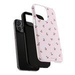 Exploded cherry-pattern case showing a triple-camera phone, liner and shell #iphone-15-pro