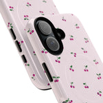 Close-up of overlapping cherry-pattern cases with vertical dual-camera opening #iphone-16